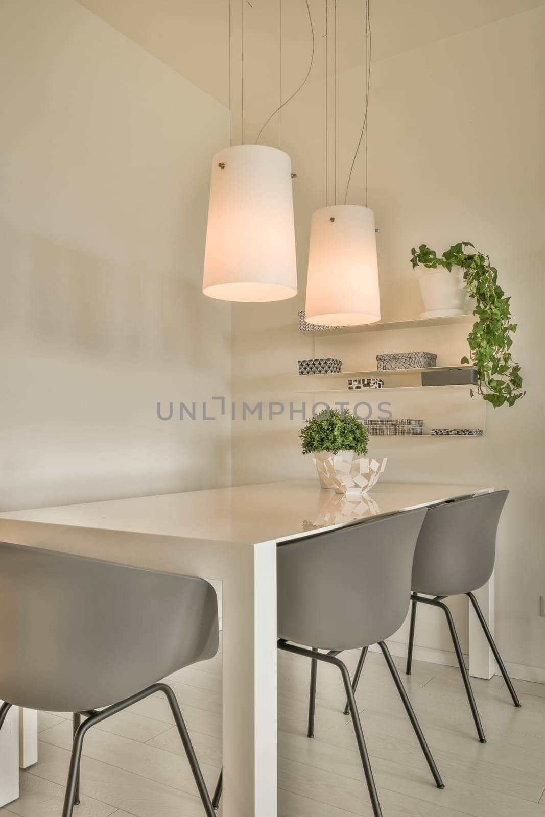 a dining room with a table and chairs and lamps by casamedia
