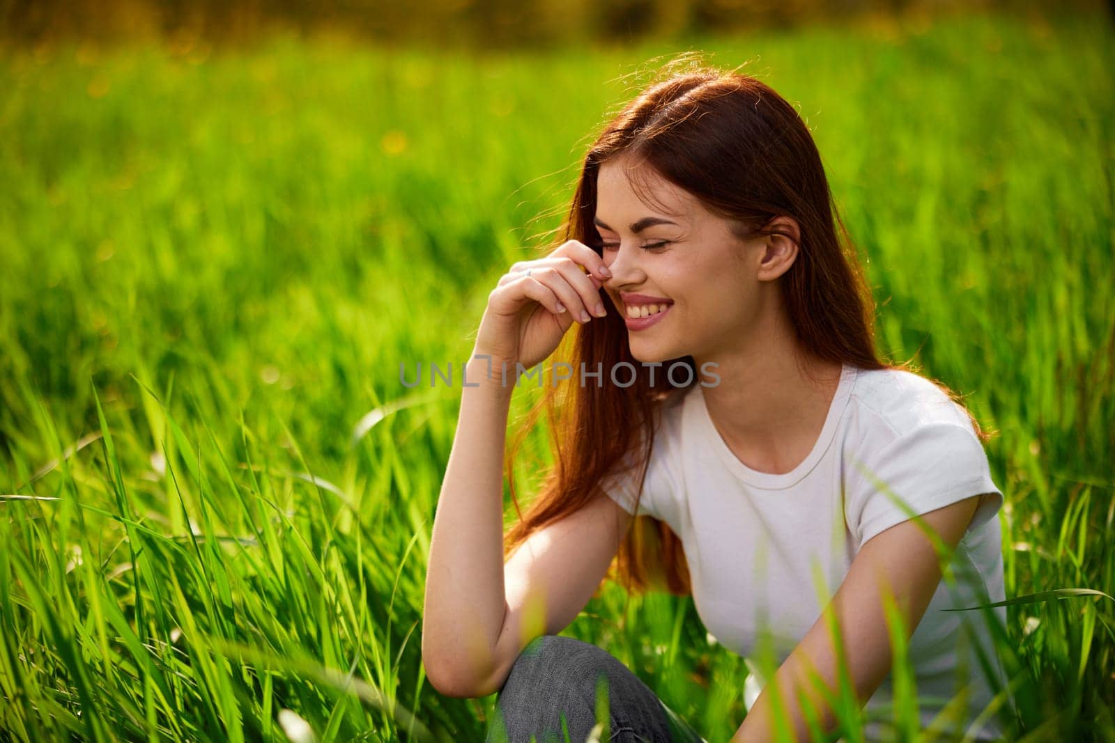 portrait of a happy woman in a white t-shirt with her hands folded in front of her face. High quality photo