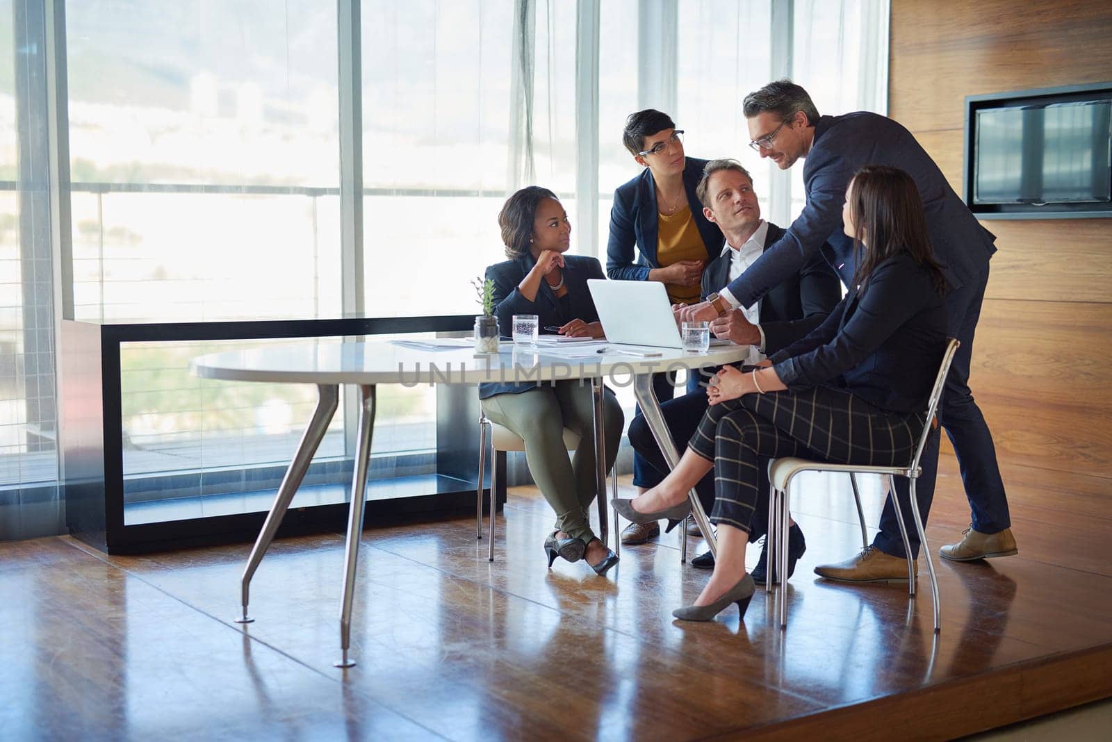 Contributing to the team. a group of corporate businesspeople working in the boardroom