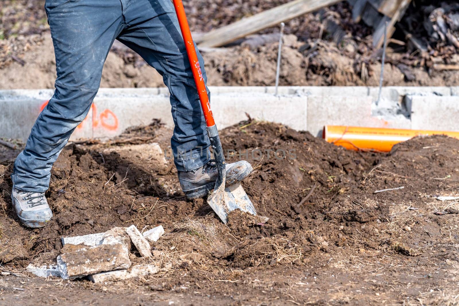 digging in the ground for plastic pipes for water and waste.