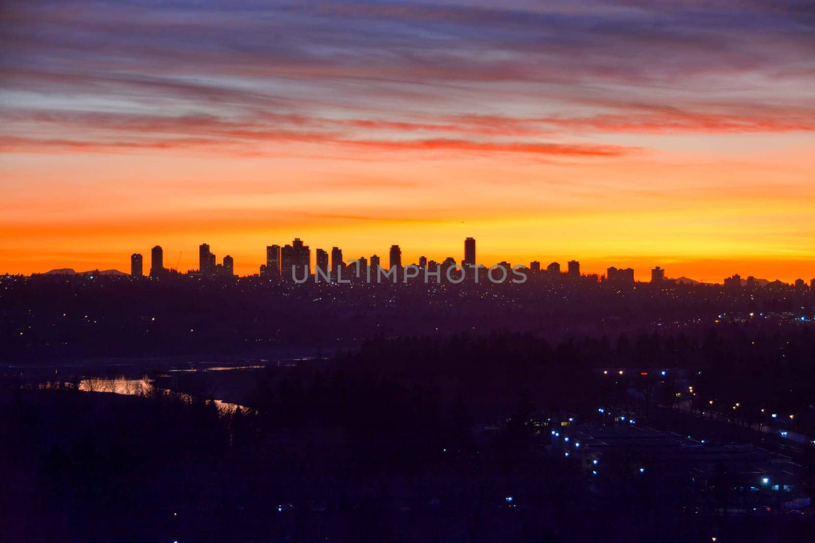 Urban and suburban residential area on sunset sky background.