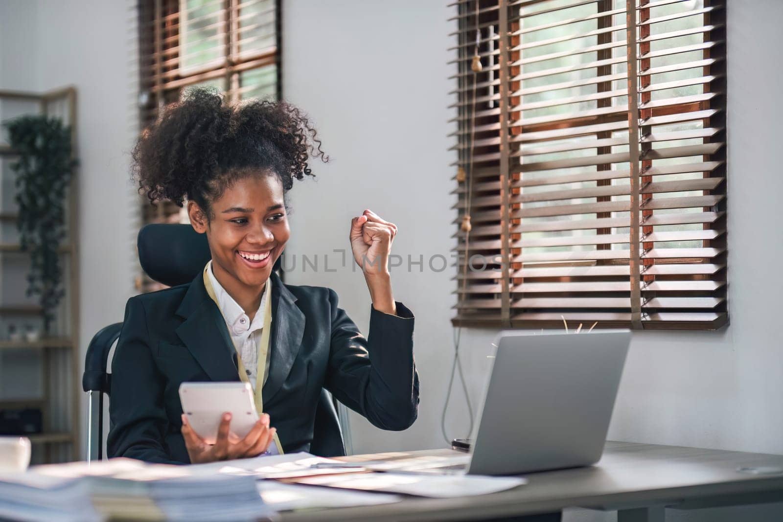 Business woman using calculator for do math finance on wooden desk in office and business working background, tax, accounting, statistics and analytic research concept.. by wichayada