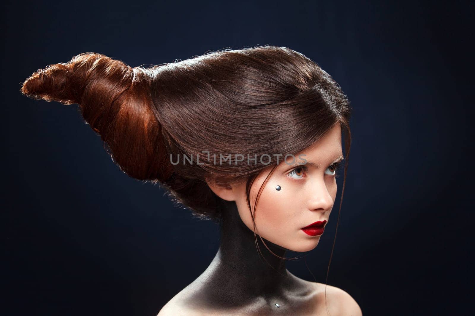 Beautiful girl with a haird in the form of horns. Ads for hairdressers.