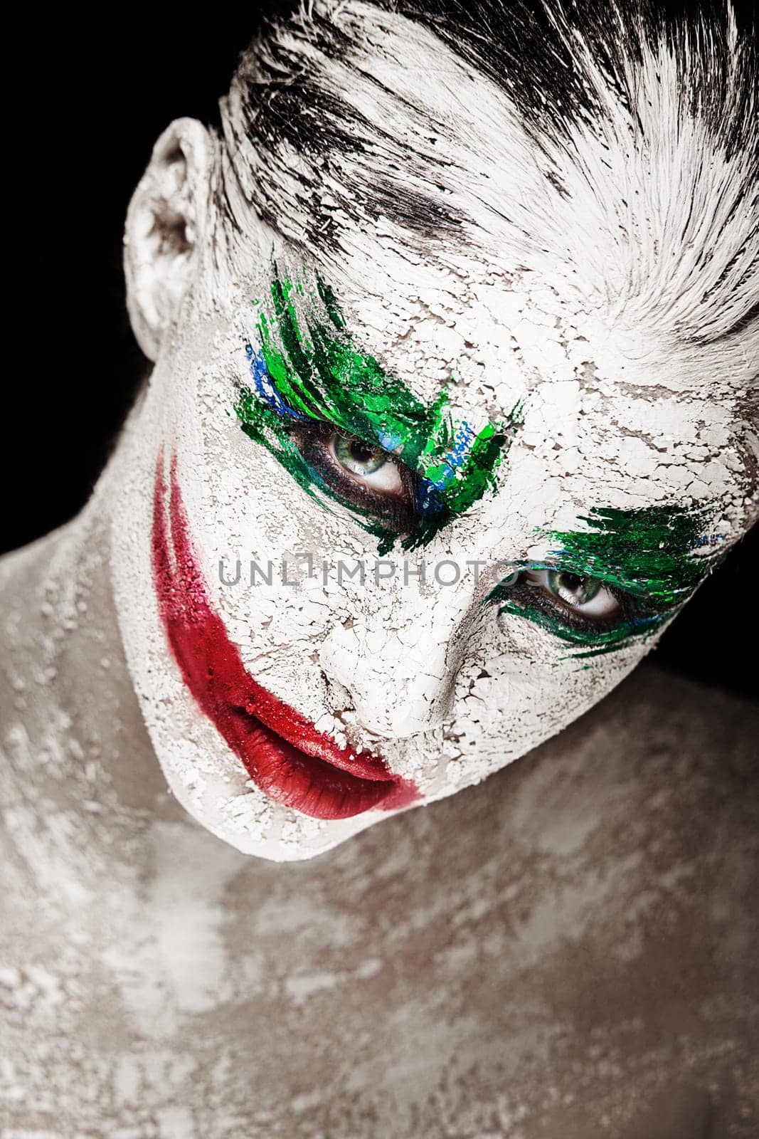 Horror portrait of a girl with an creative make-up in joker style