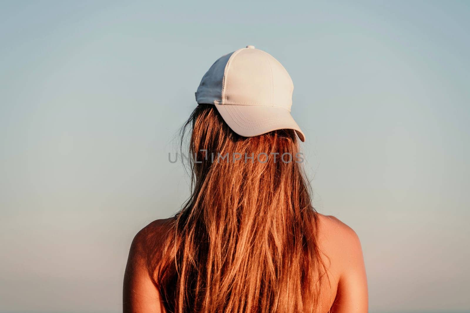 Portrait of a woman in a cap on the background of the sea by Matiunina