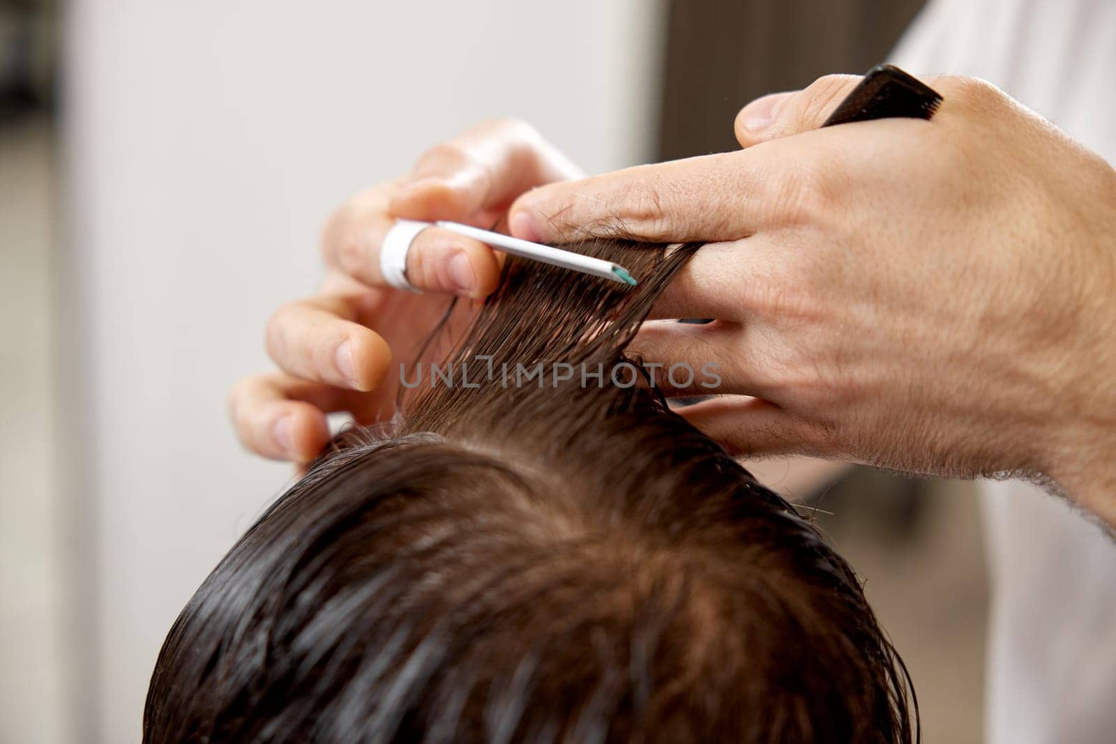 young caucasian man getting haircut by professional male hairstylist by erstudio