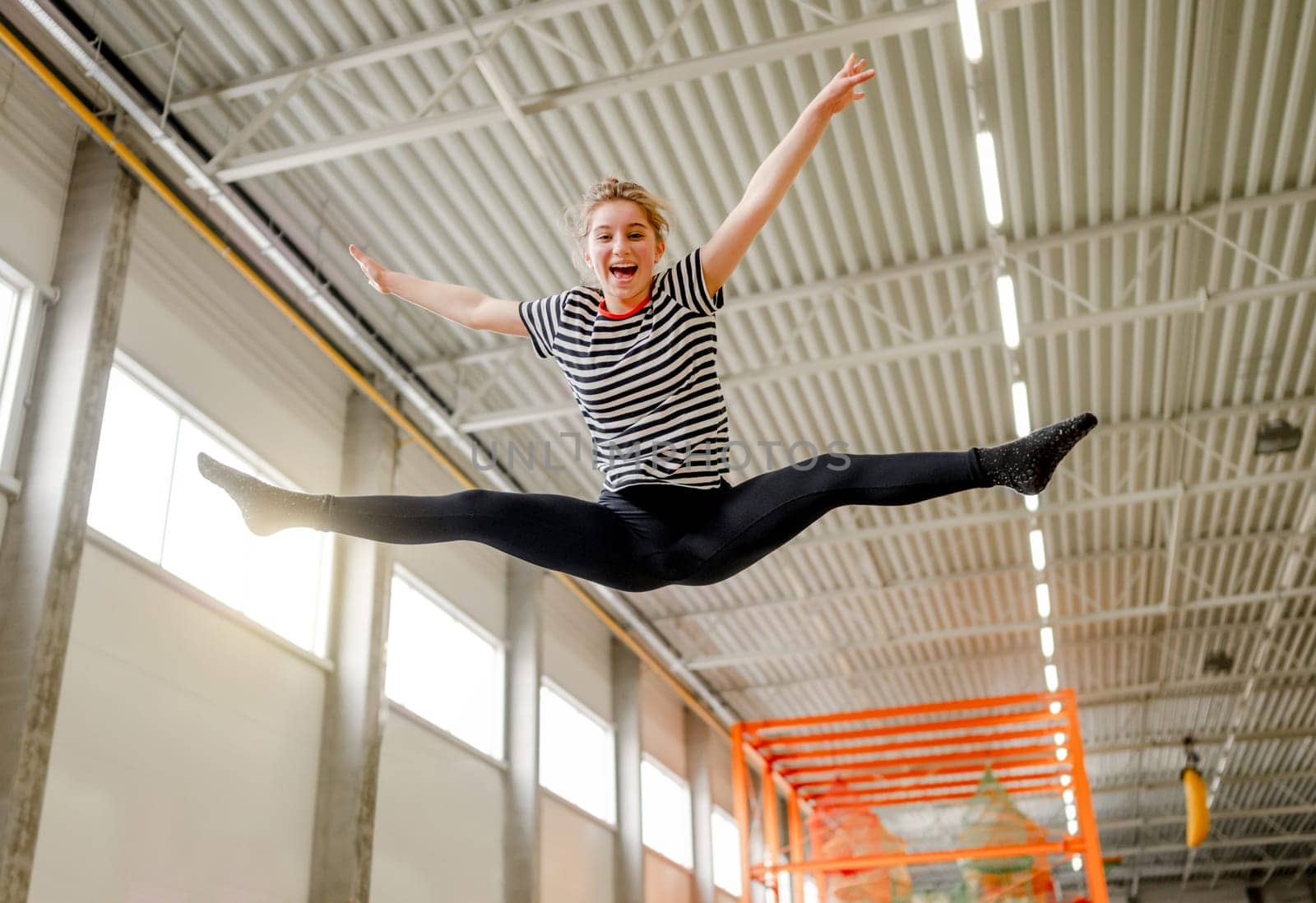 Pretty girl in trampoline park having fun by tan4ikk1