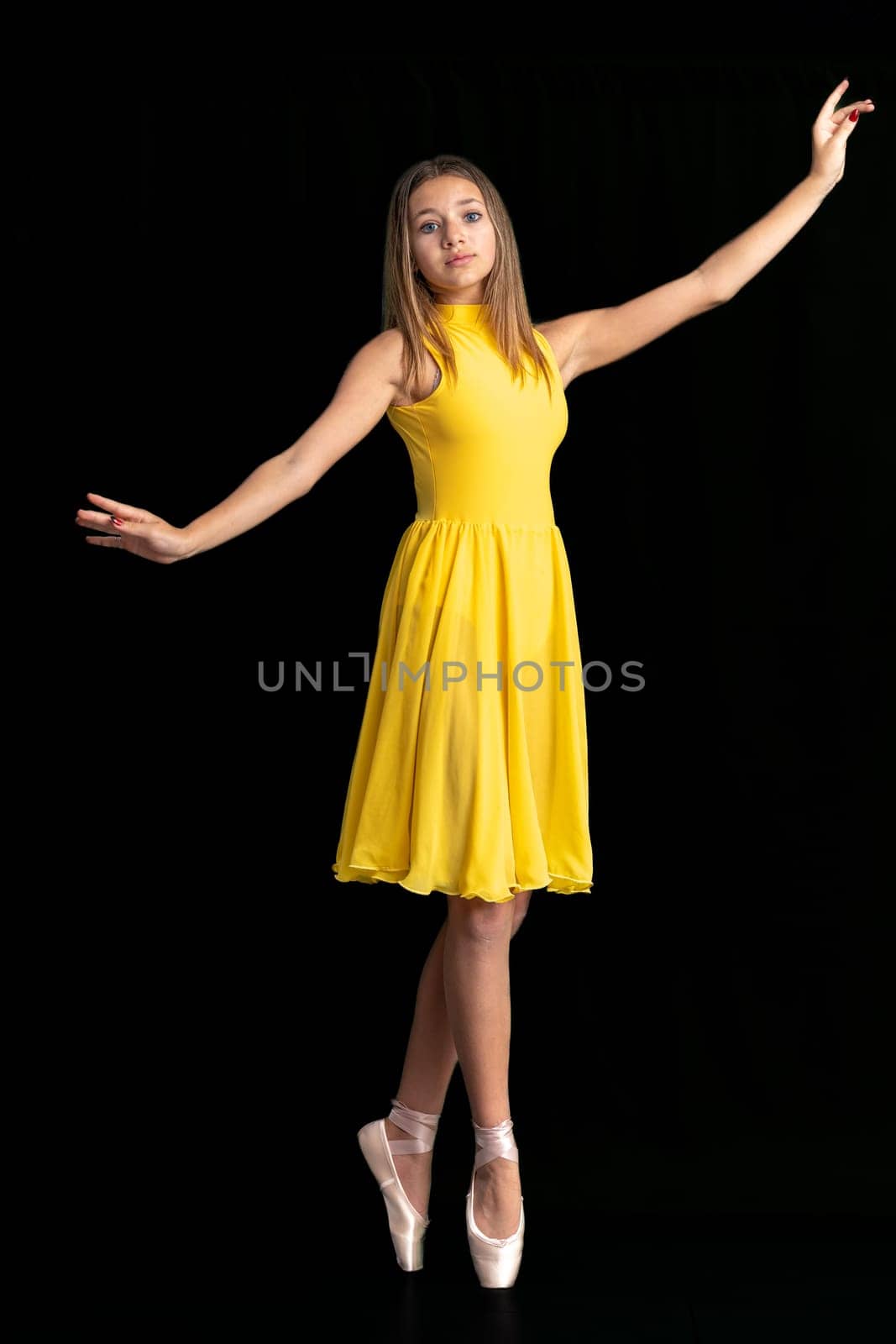 portrait of a teenage ballerina in a suit on a black background by Edophoto
