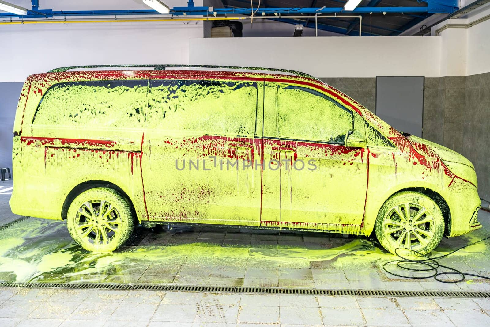 wash cars with green active foam in the garage. High quality photo