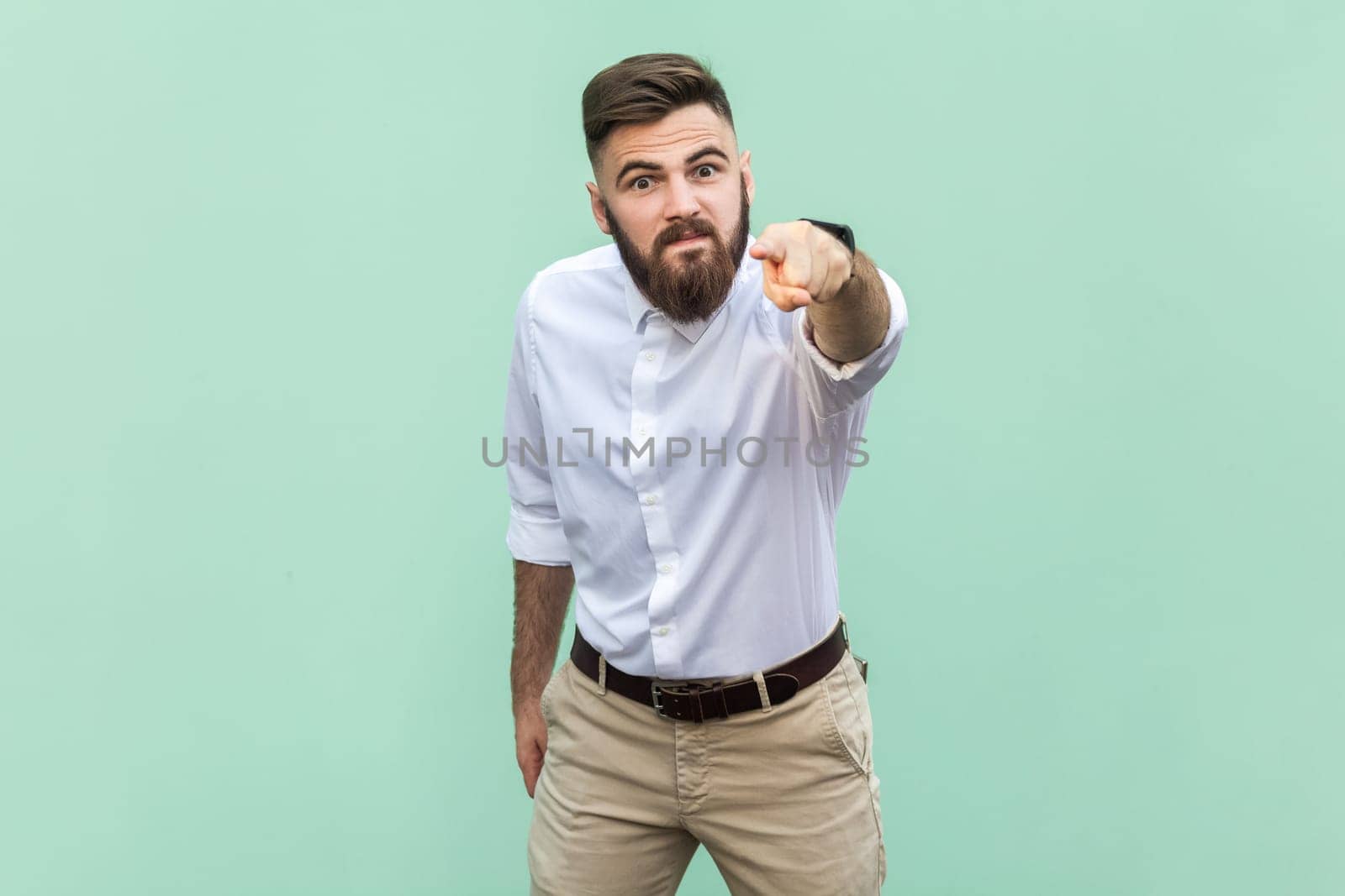 Businessman looking at camera with serious expression, pointing at you, expressing anger and hate. by Khosro1