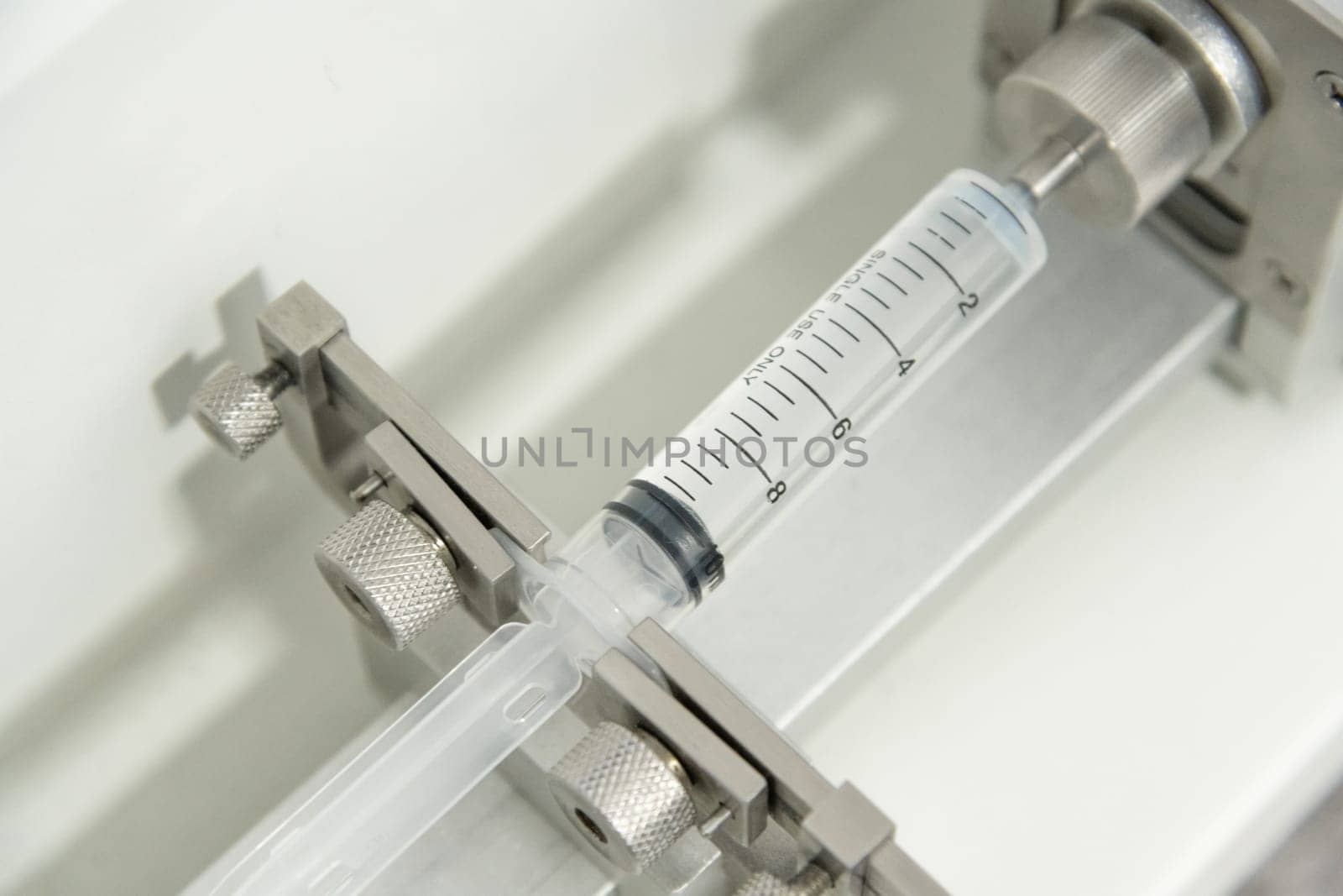 A closeup of the production and testing of medical syringes and droppers by A_Karim