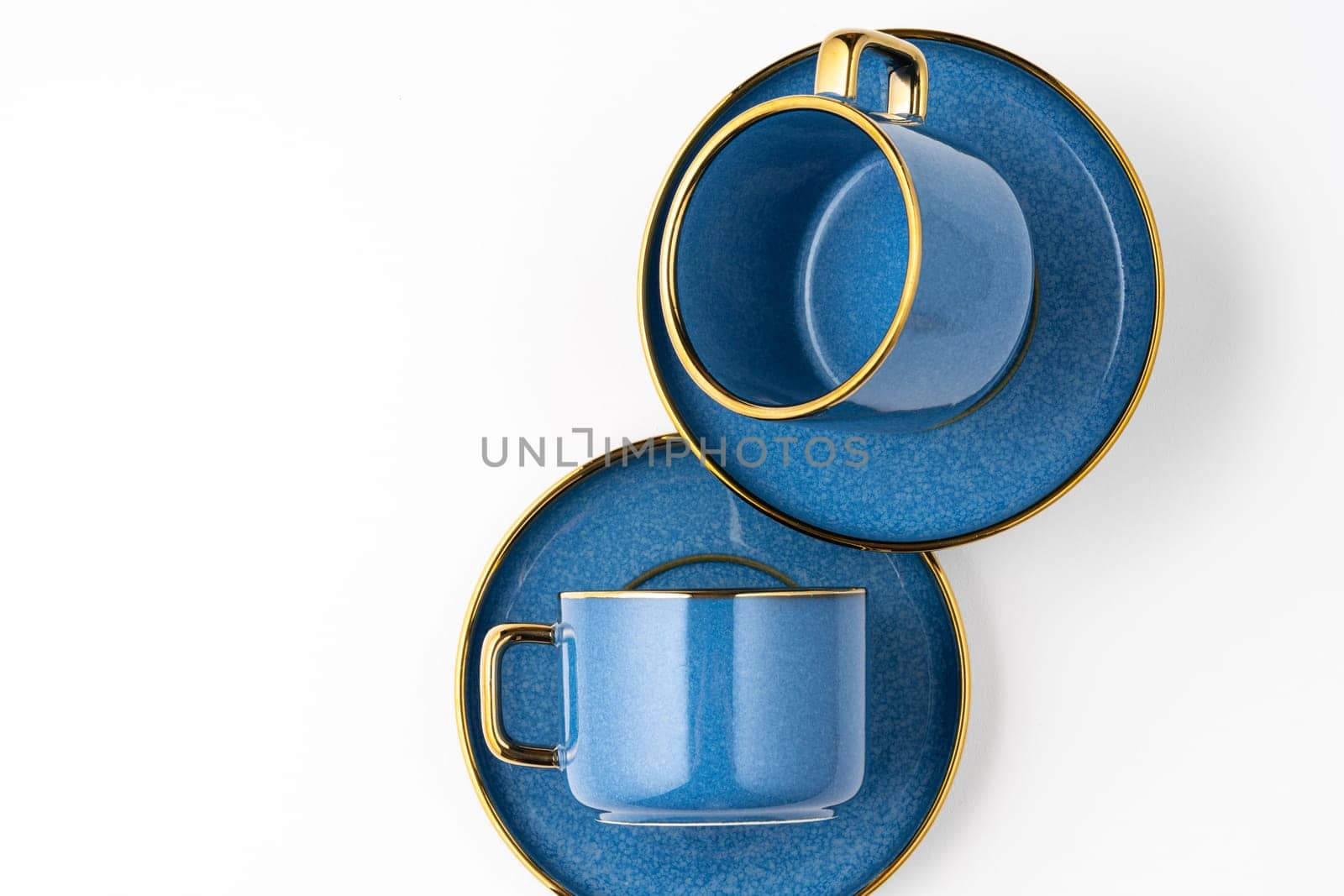 A set of blue ceramic plates and cup on a white background. Top view