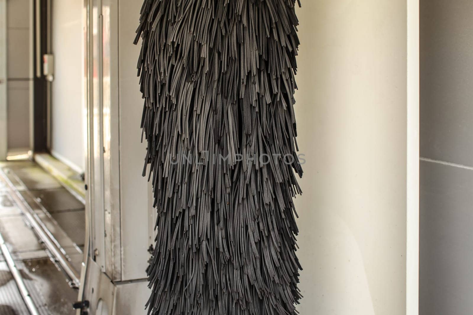 Black rotating brush in carwash