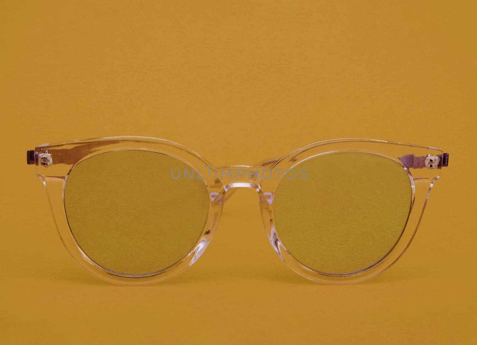 Yellow glasses with a transparent frame on a yellow background. by gelog67