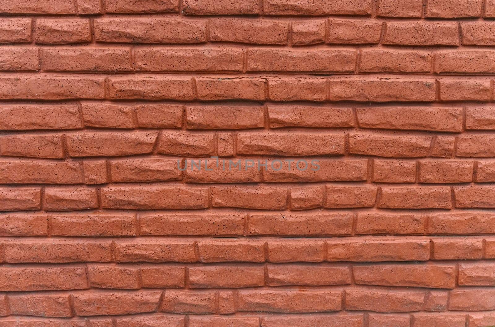 The texture of the concrete wall is made to look like a brick and painted brown-red.