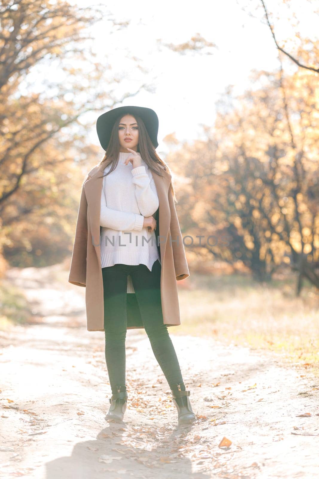 beautiful young woman in coat and black hat by erstudio