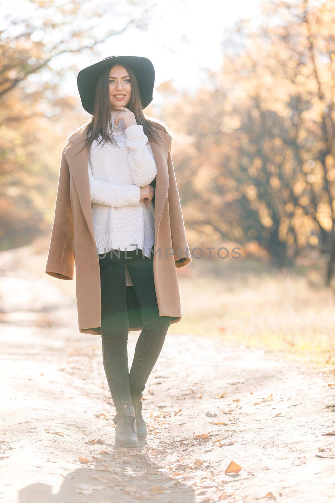 beautiful young woman in coat and black hat by erstudio