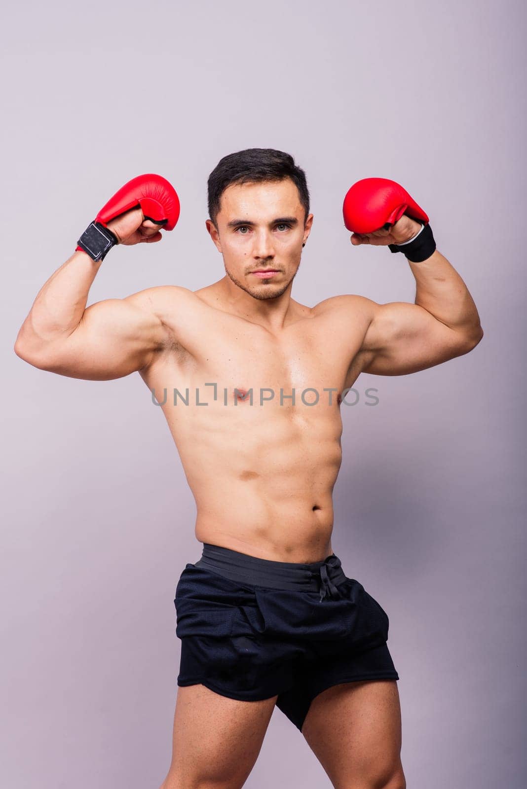 Professional athlete boxer in red gloves who isolated on studio. Sport, competition concept. by Zelenin