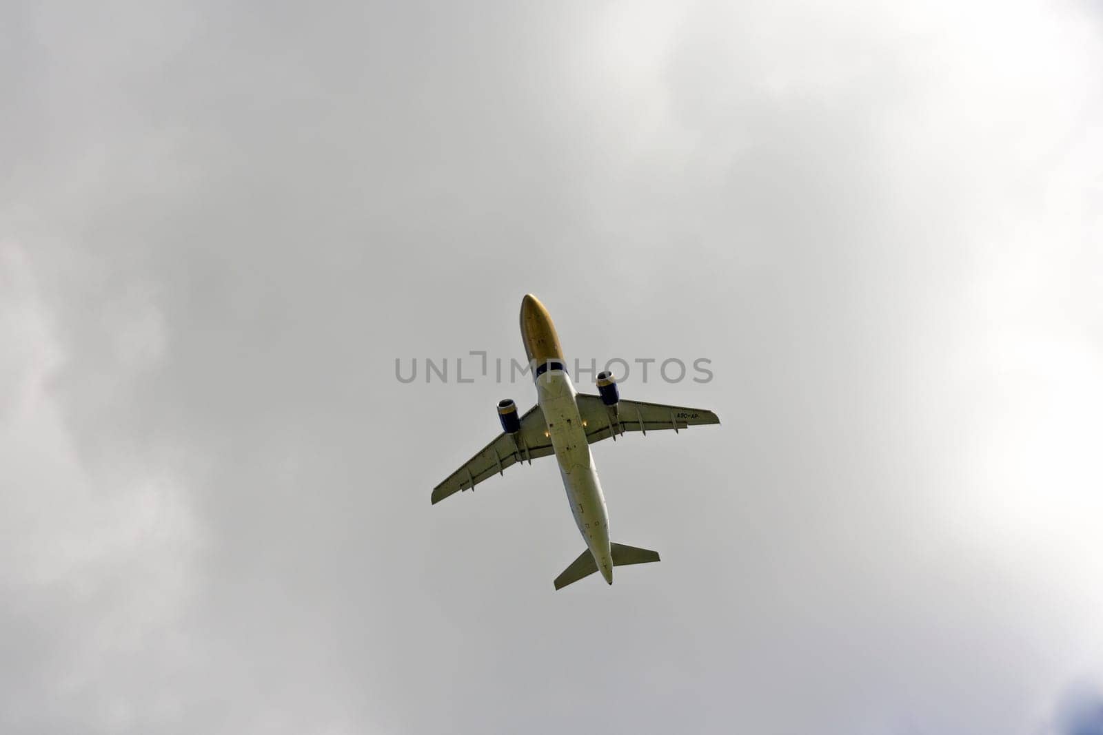 Airplane flies against a background of white clouds