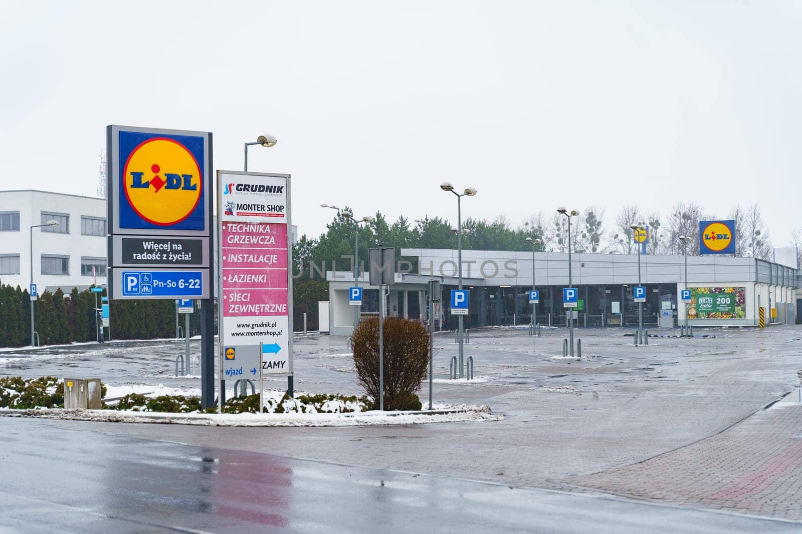 Empty parking lot in front of Lidl store. The supermarket is closed, Sunday. by Sd28DimoN_1976
