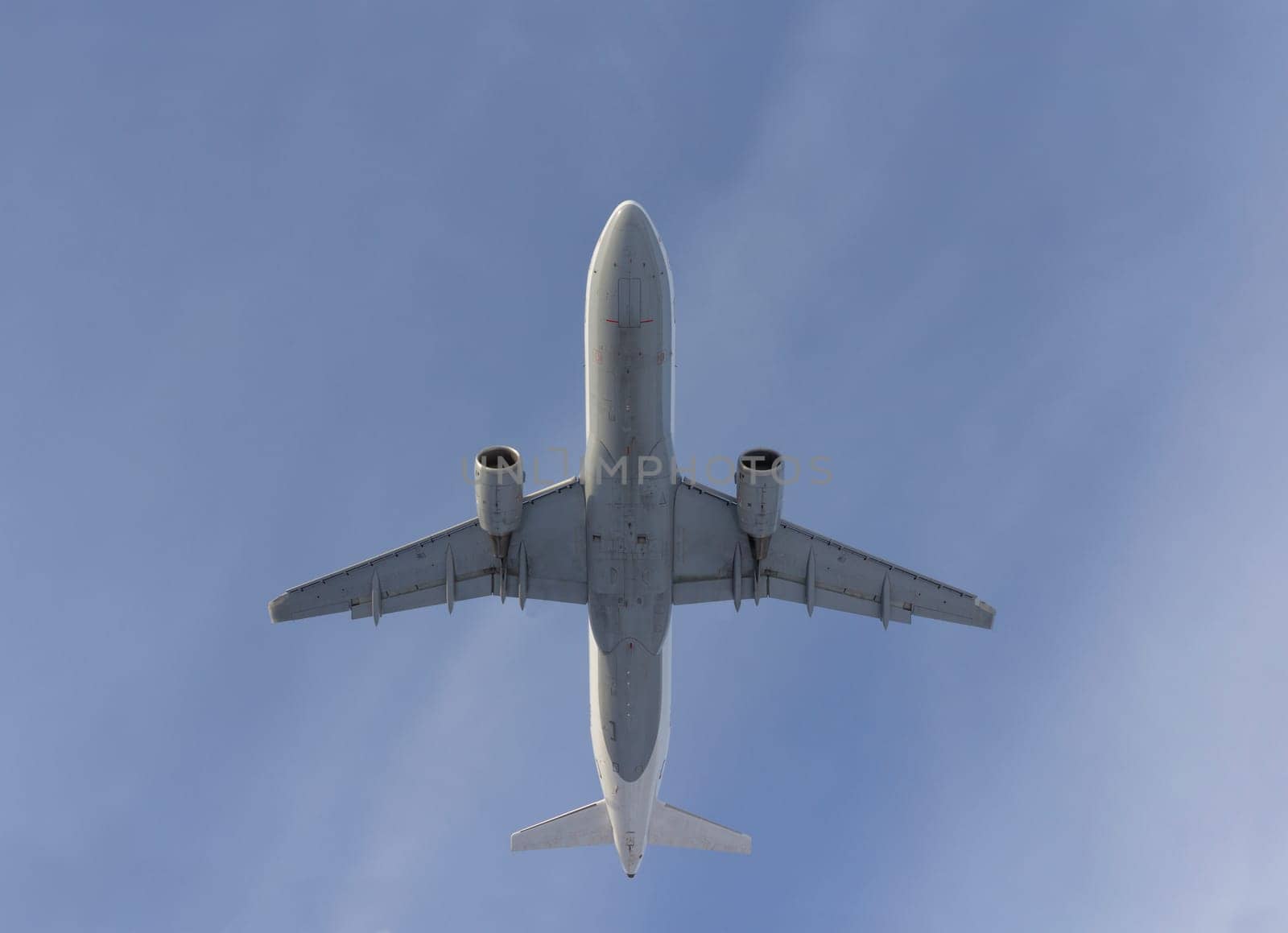 Airplane flies against a background of white clouds