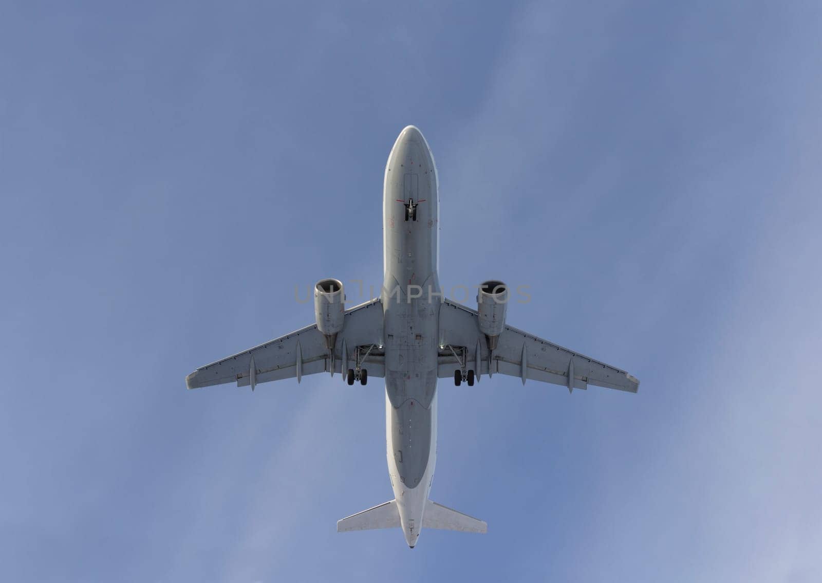 Airplane flies against a background of white clouds