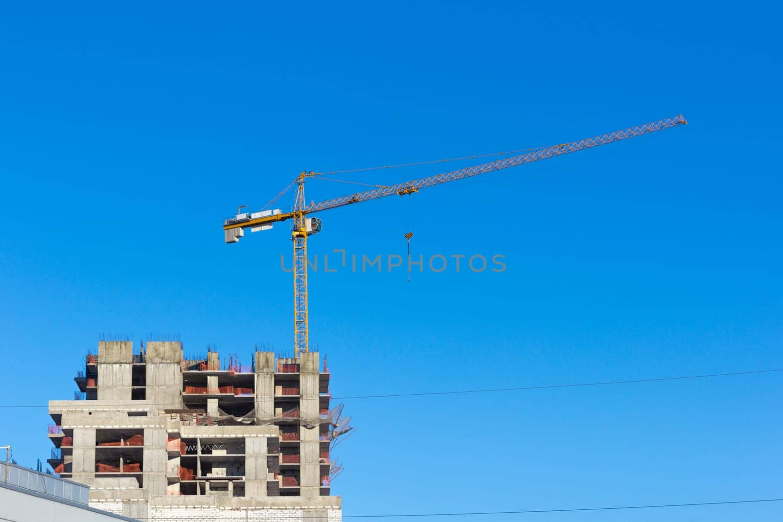 Construction site with two cranes against the sky