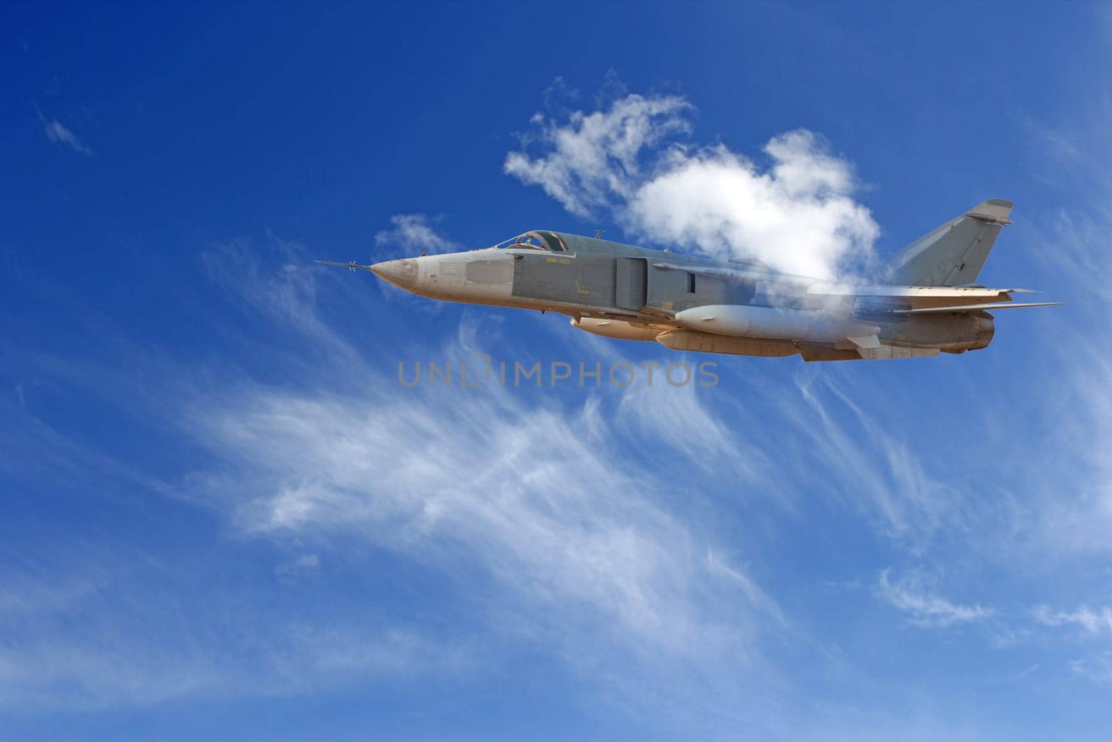 Military jet bomber Su-24 Fencer flying above the clouds.