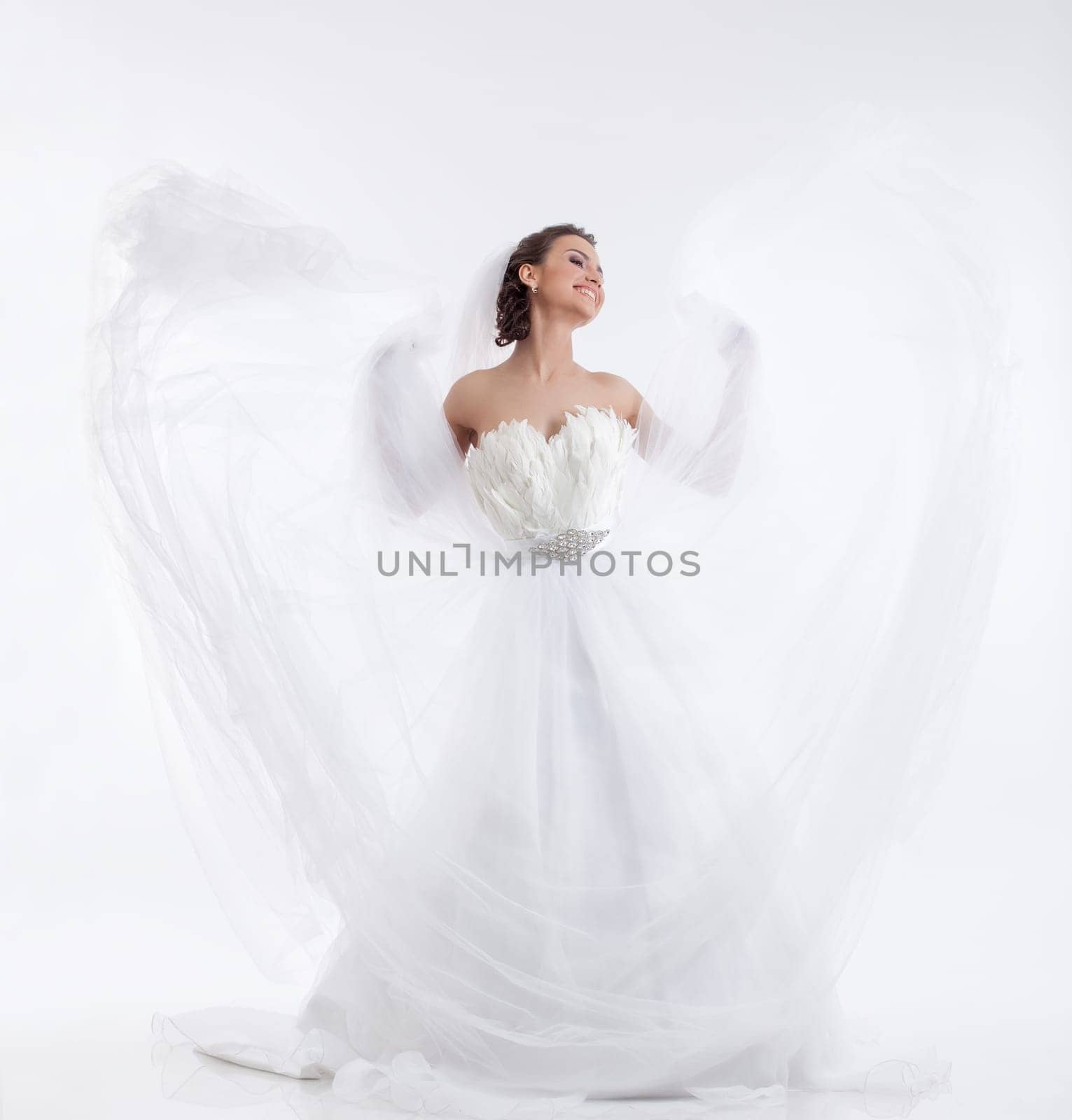 Cheerful beautiful bride isolated on white background