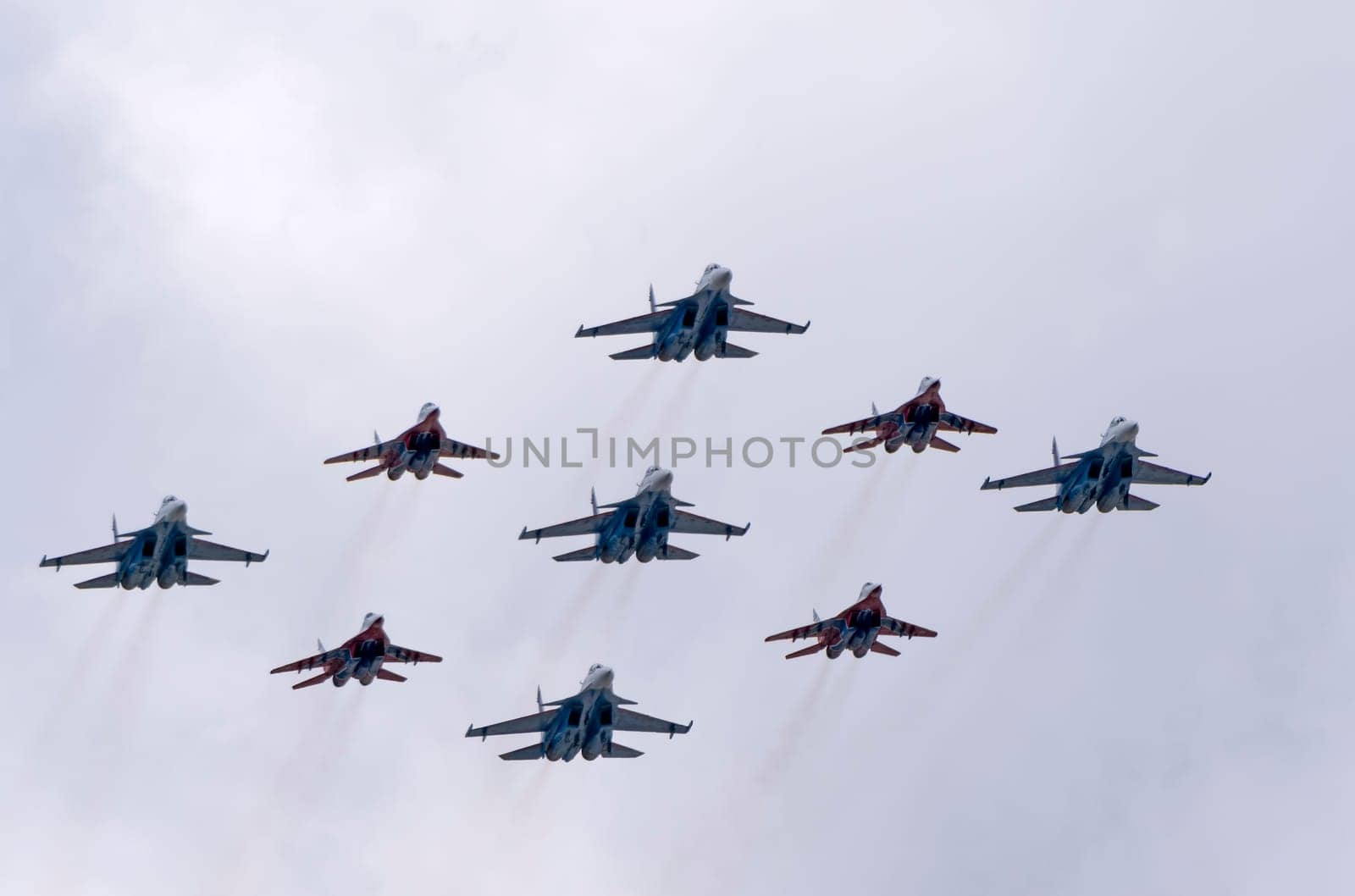 MOSCOW, RUSSIA - MAY 7, 2021: Avia parade in Moscow. group jet fighter aircraft MiG-35 and Su-30 in the sky on parade of Victory in World War II in Moscow, Russia