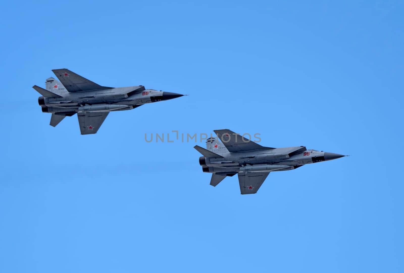 MOSCOW, RUSSIA - MAY 7, 2021: Avia parade in Moscow. group jet fighter aircraft Mikoyan MiG-31 in the sky on parade of Victory in World War II in Moscow, Russia
