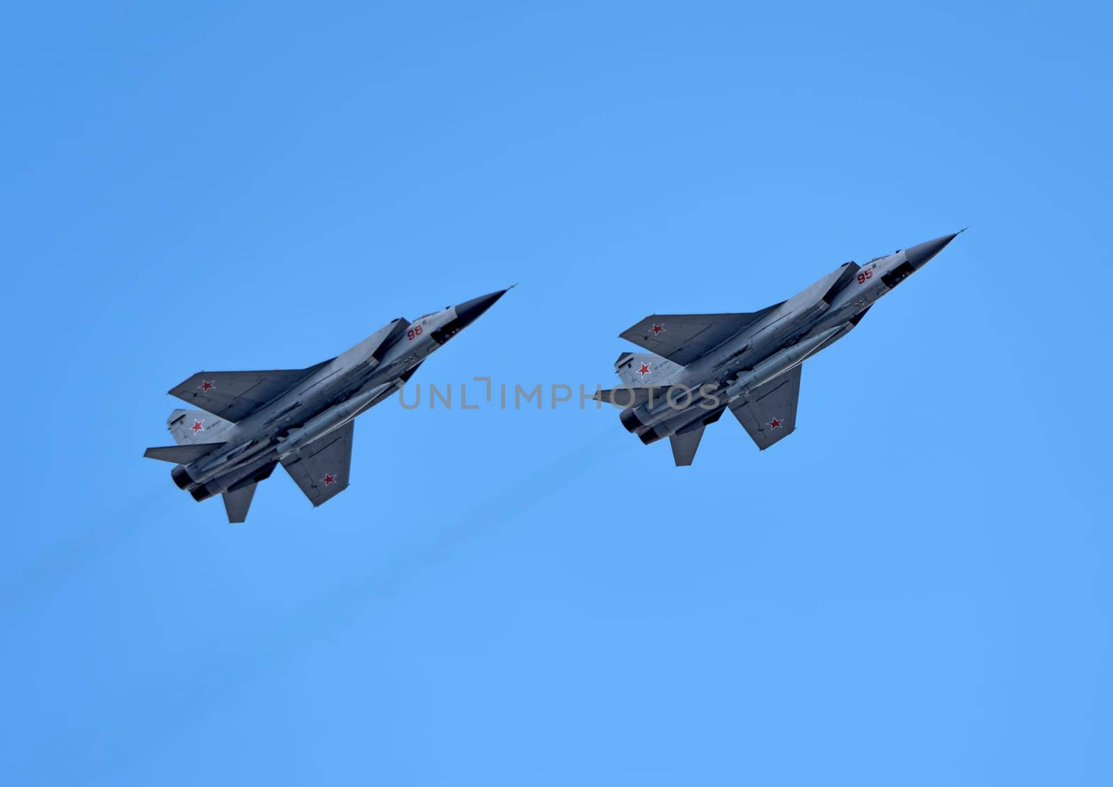 MOSCOW, RUSSIA - MAY 7, 2021: Avia parade in Moscow. group jet fighter aircraft Mikoyan MiG-31 in the sky on parade of Victory in World War II in Moscow, Russia