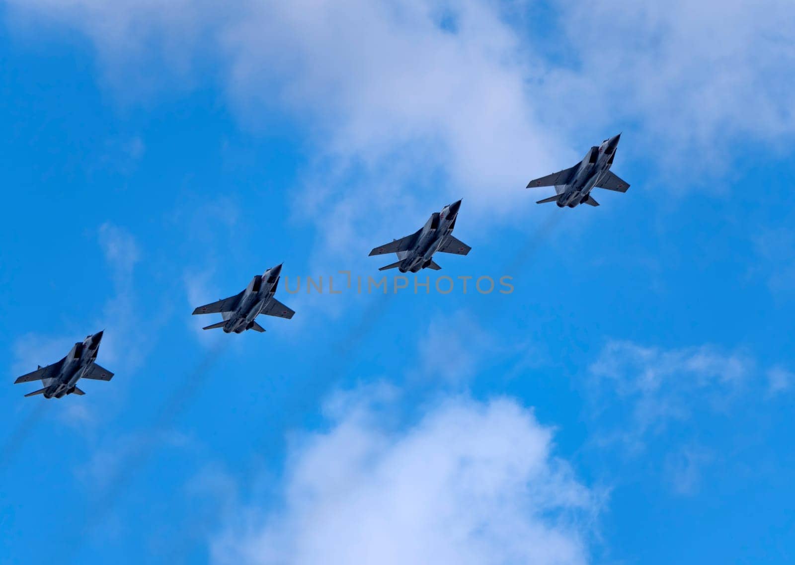 MOSCOW, RUSSIA - MAY 7, 2021: Avia parade in Moscow. group jet fighter aircraft Mikoyan MiG-31 in the sky on parade of Victory in World War II in Moscow, Russia