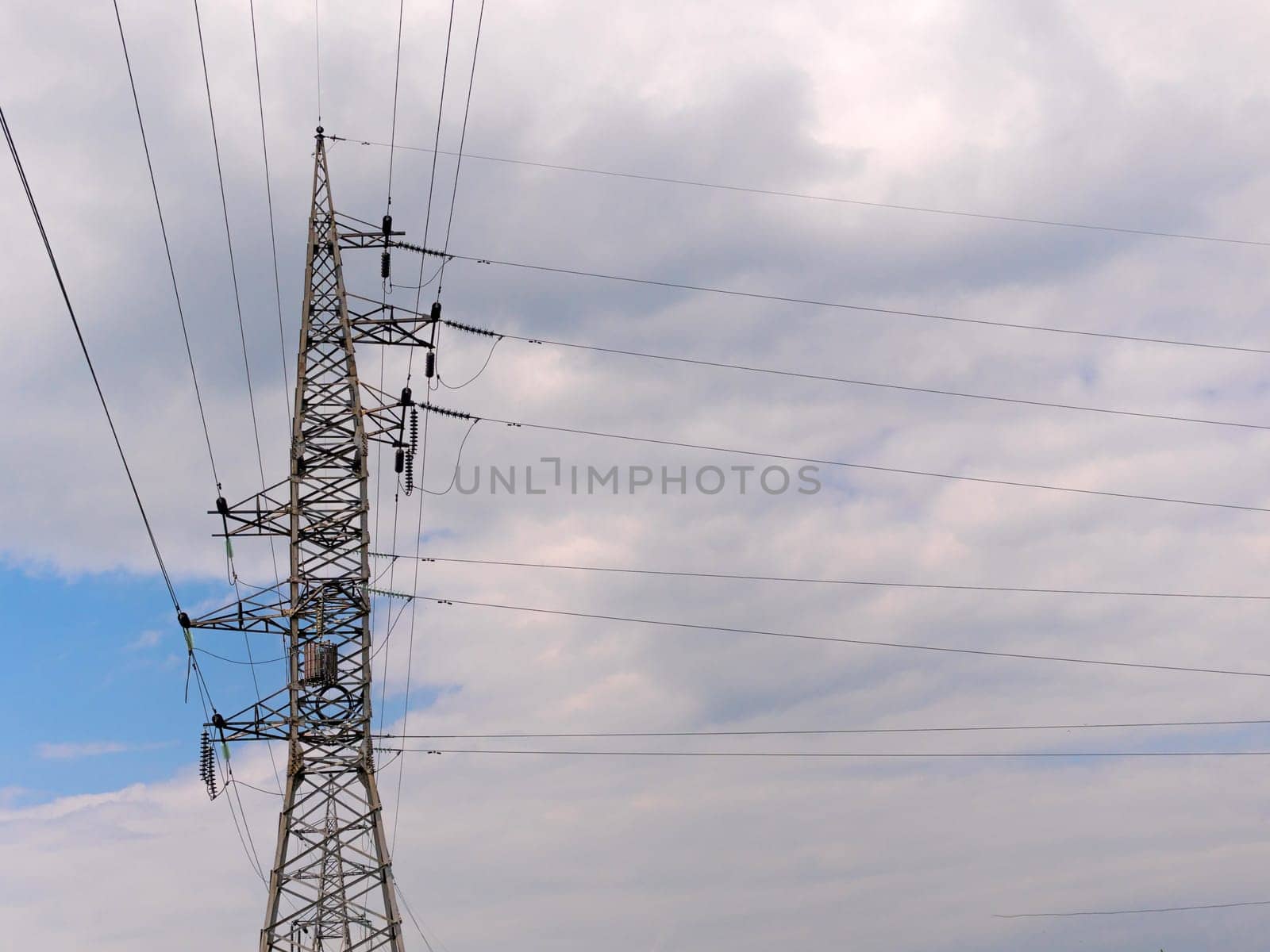cloudy morning sky and a high-voltage line.