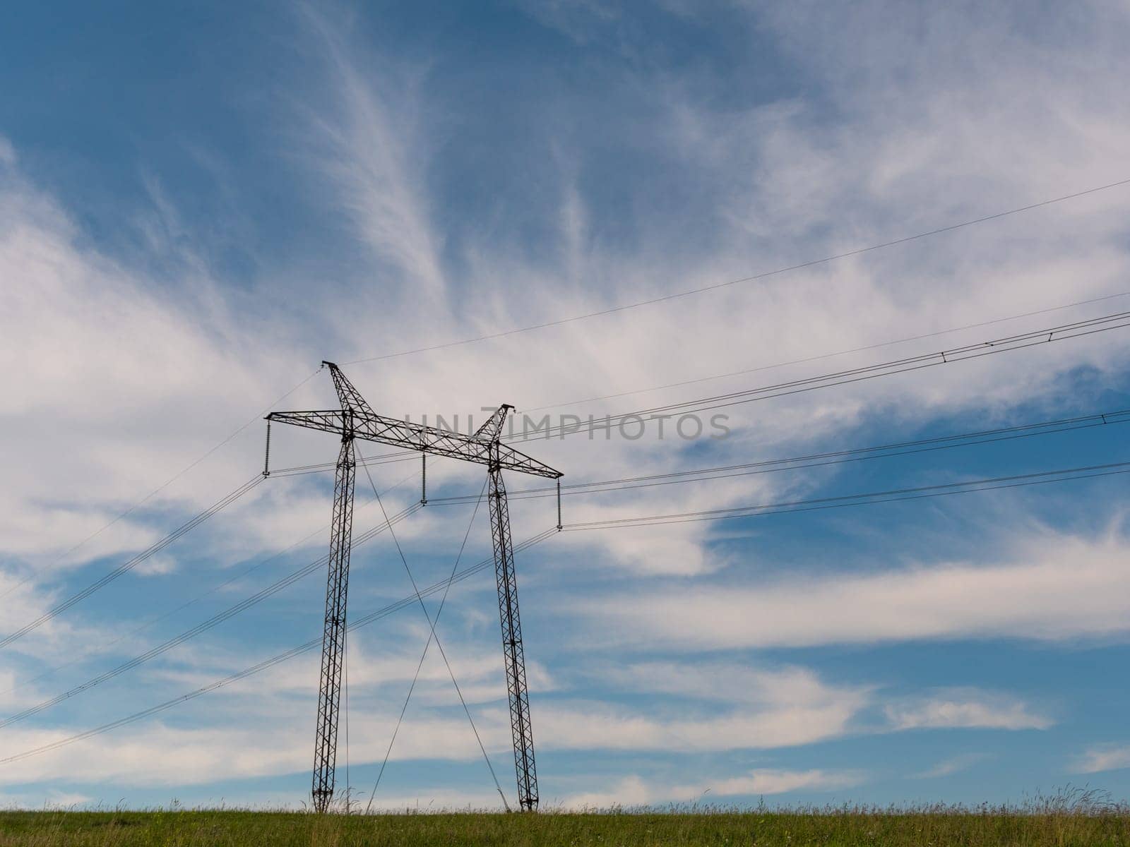 cloudy morning sky and a high-voltage line.