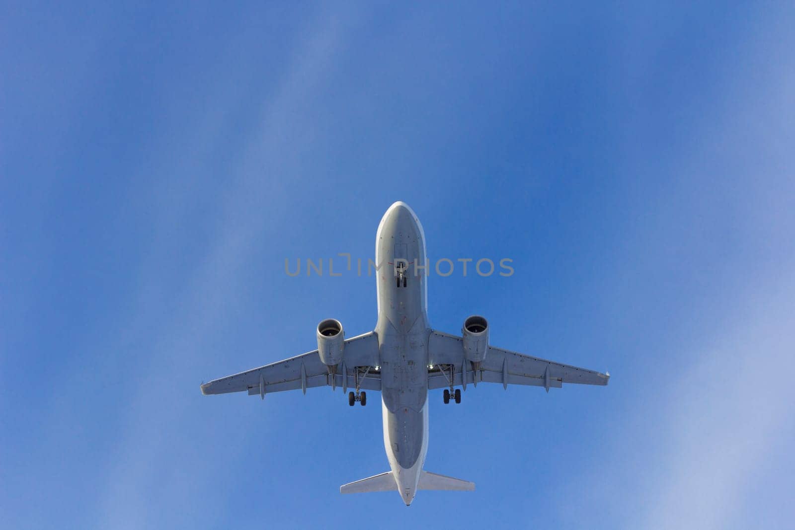 Airplane flies against a background of white clouds
