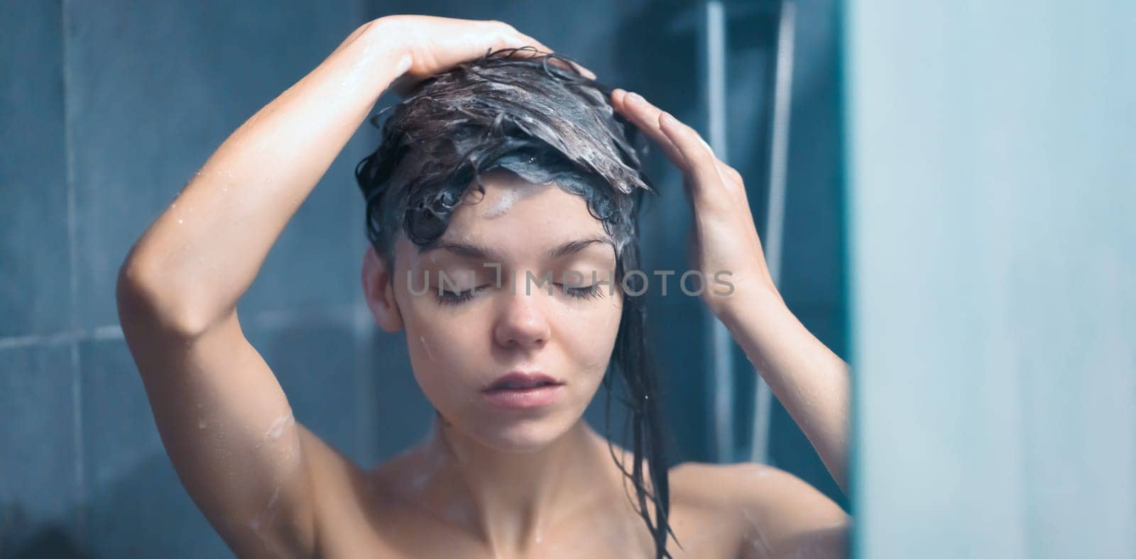 Girl takes a shower, washes her hair. by africapink