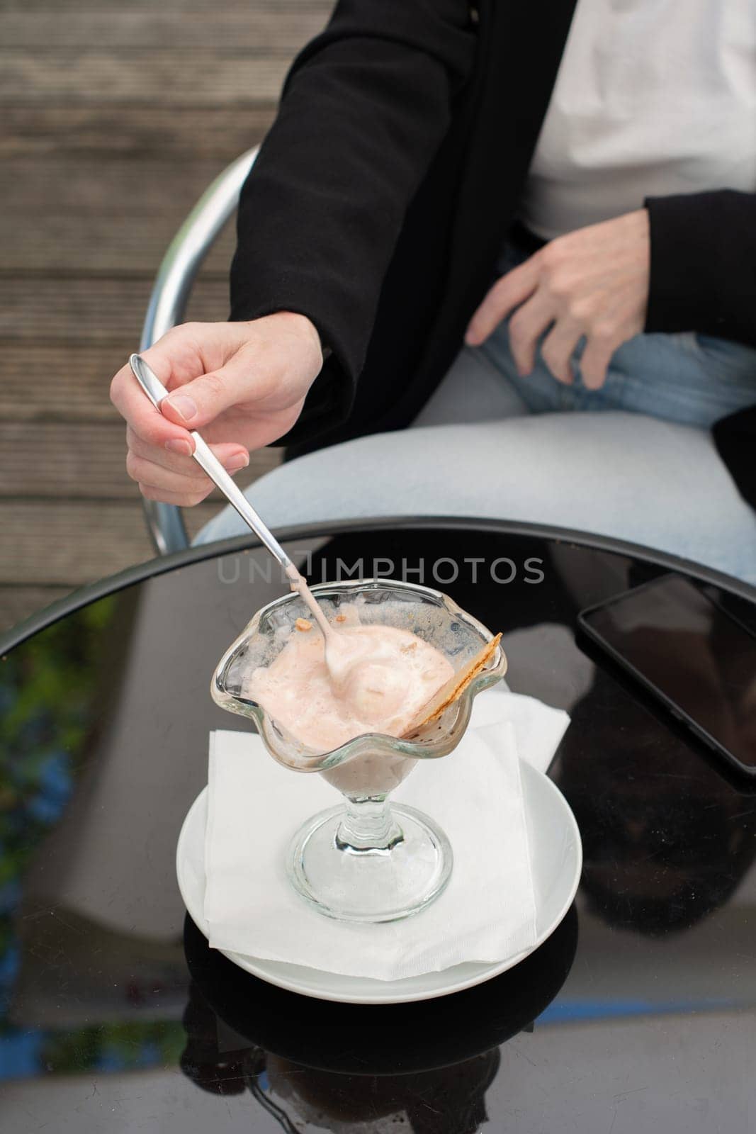 faceless photo business woman thoughtfully notes melted ice cream in a bowl by KaterinaDalemans