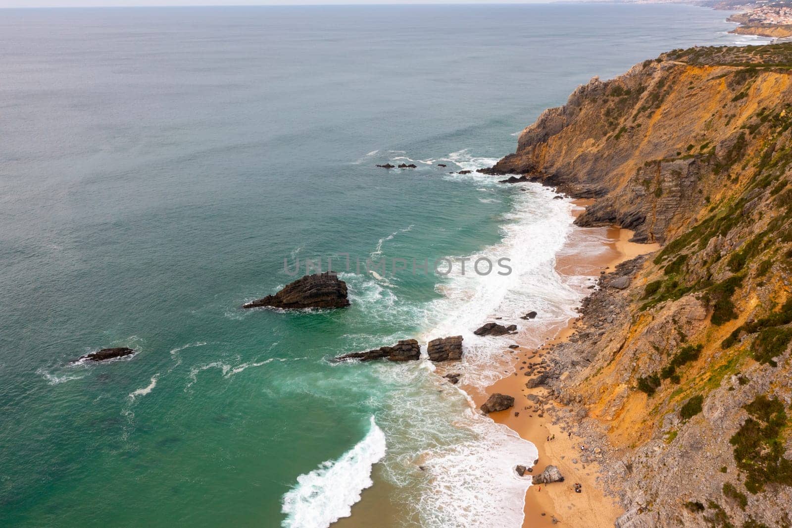 Aerial Drone View of Portugal Atlantic Coast at Lisbon, a Dramatic Rugged Rocky Coastline with Waves Crashing and Breaking Against Rocks at Sunrise, Sintra, Praia da Adraga beach