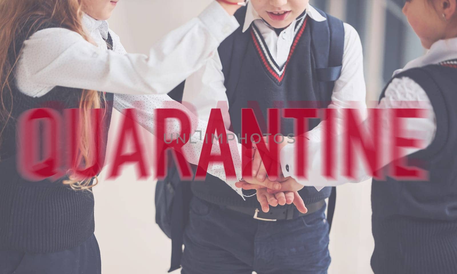 Red quarantine word. Group of kids in school uniform standing together indoors.