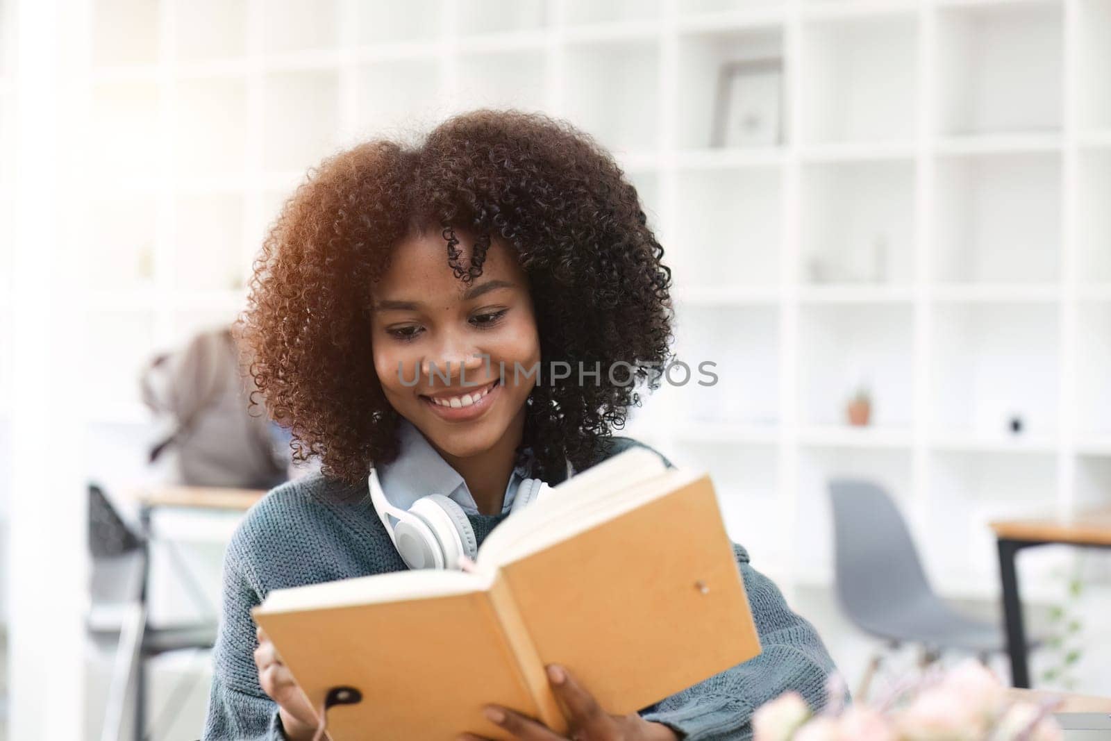 portrait of happy smile african american girl lecture on book and looking on camera.