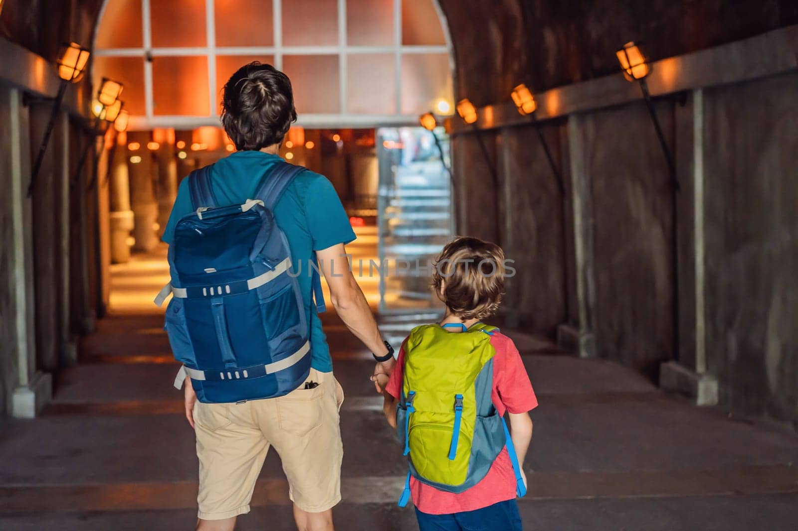 father and son tourists enjoying Beautiful cistern in Istanbul. Cistern - underground water reservoir build in 6th century, Istanbul, Turkey, Turkiye.