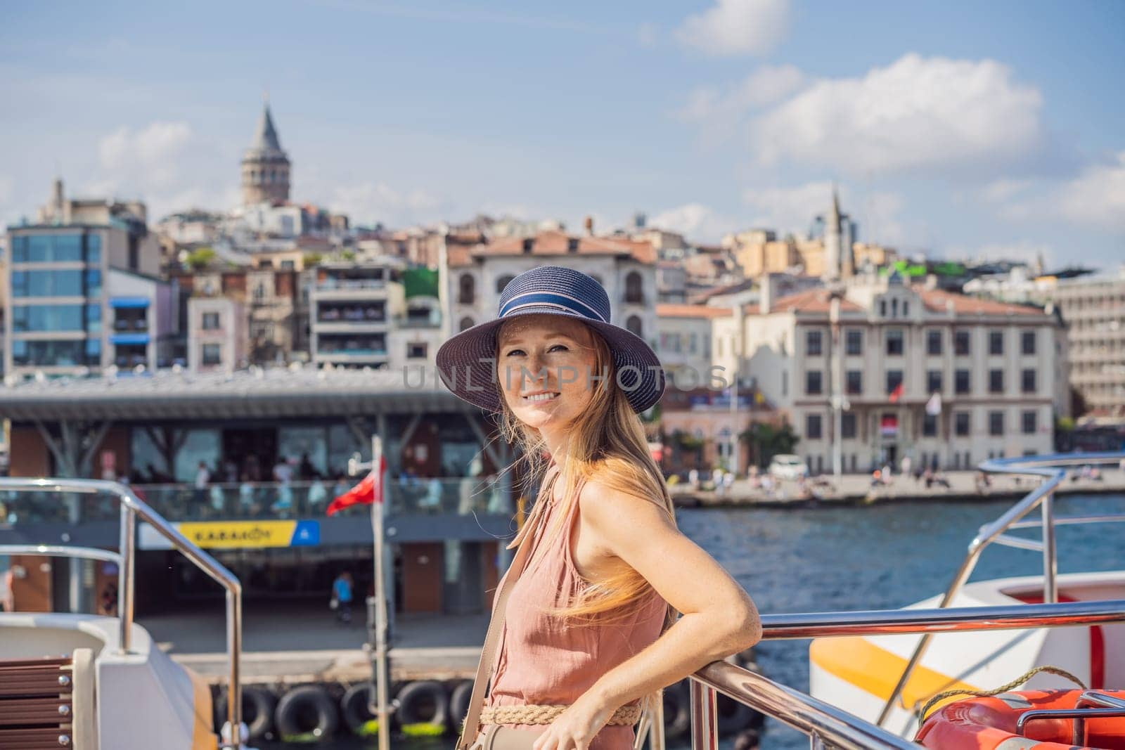 Happy woman enjoying the sea from ferry boat crossing Bosphorus in Istanbul. Summer trip to Istanbul.