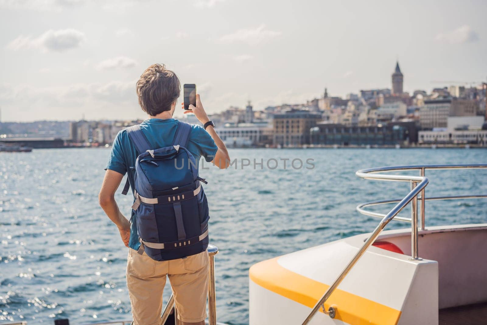 Happy man enjoying the sea from ferry boat crossing Bosphorus in Istanbul. Summer trip to Istanbul.