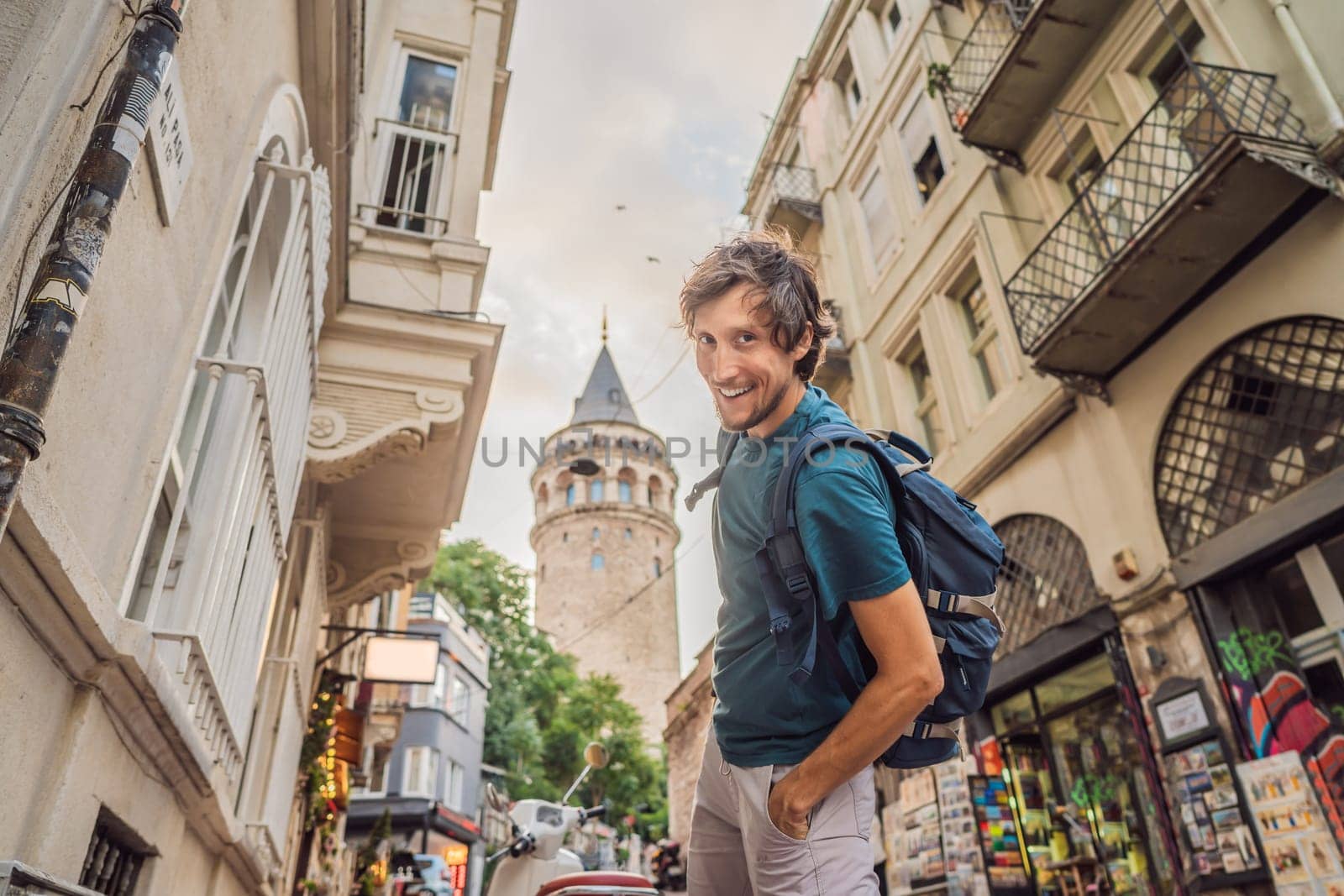 Portrait of man tourist with view of Galata tower in Beyoglu, Istanbul, Turkey. Turkiye.
