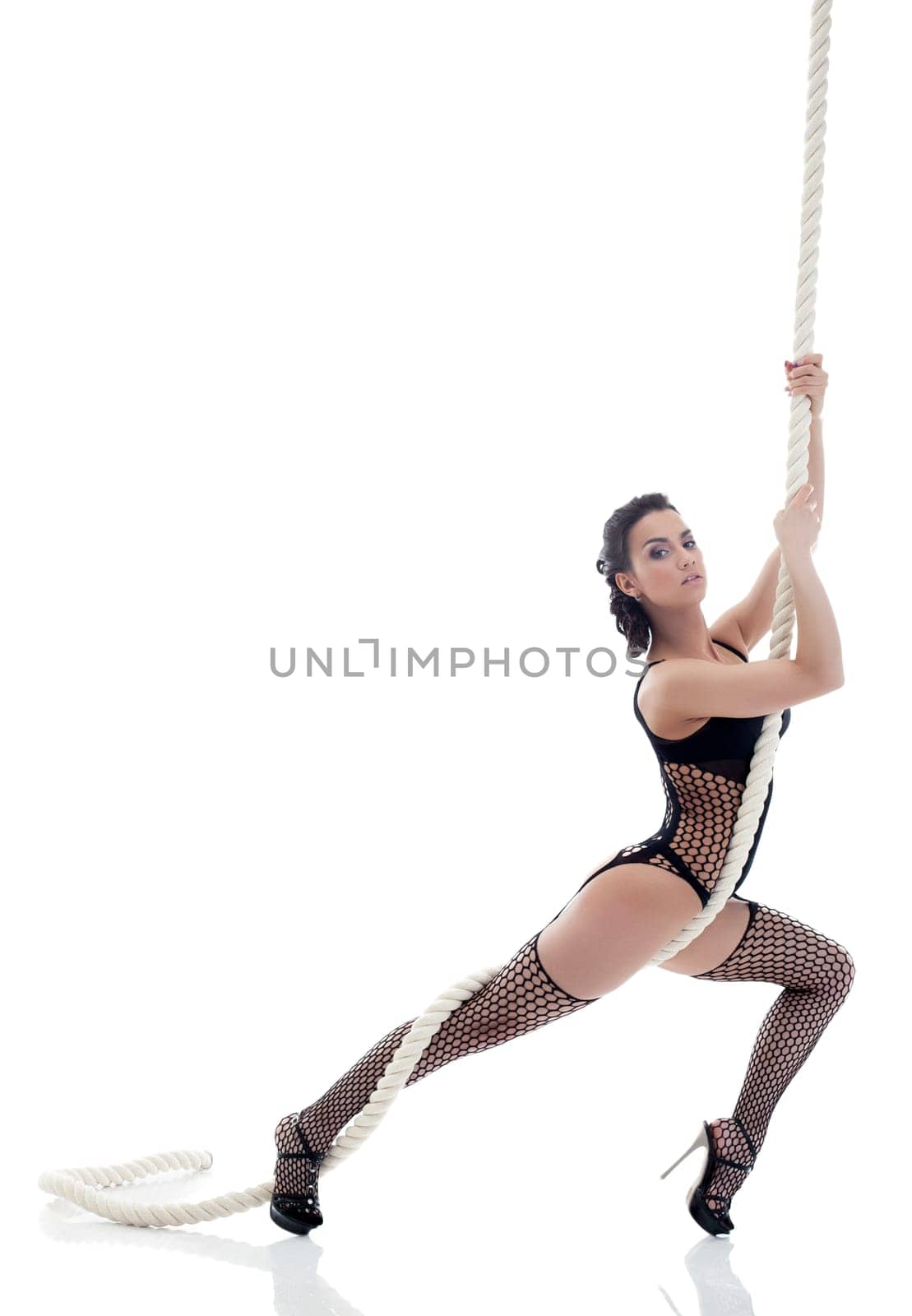 Sexy woman in black lingerie posing with rope, isolated on white