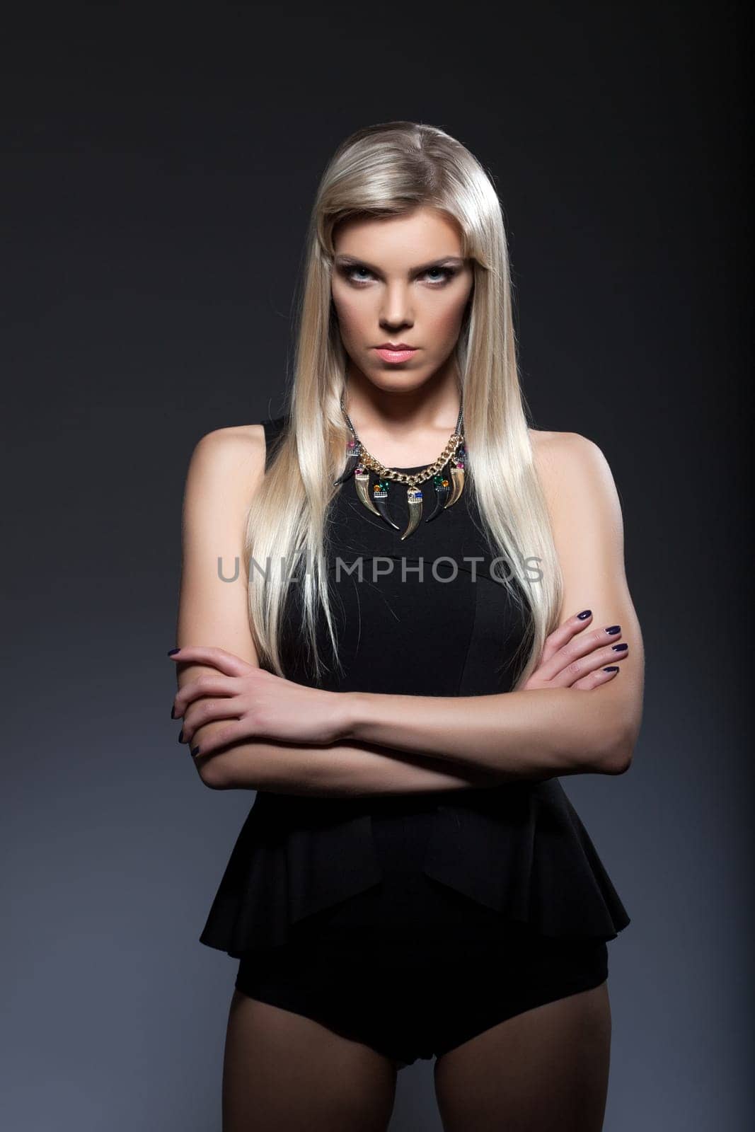 Portrait of young strict blonde looking at camera, close-up