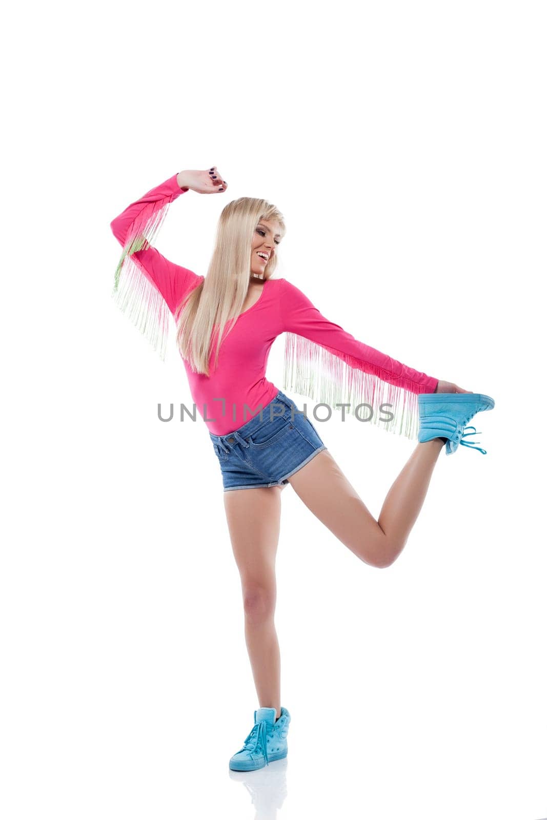 Smiling slender blonde posing in sports wear, isolated on white