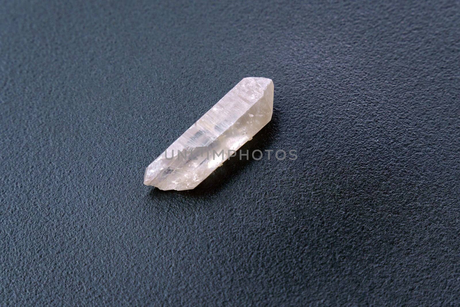 Natural mineral from geological collection raw clear quartz rock crystal stone, black background