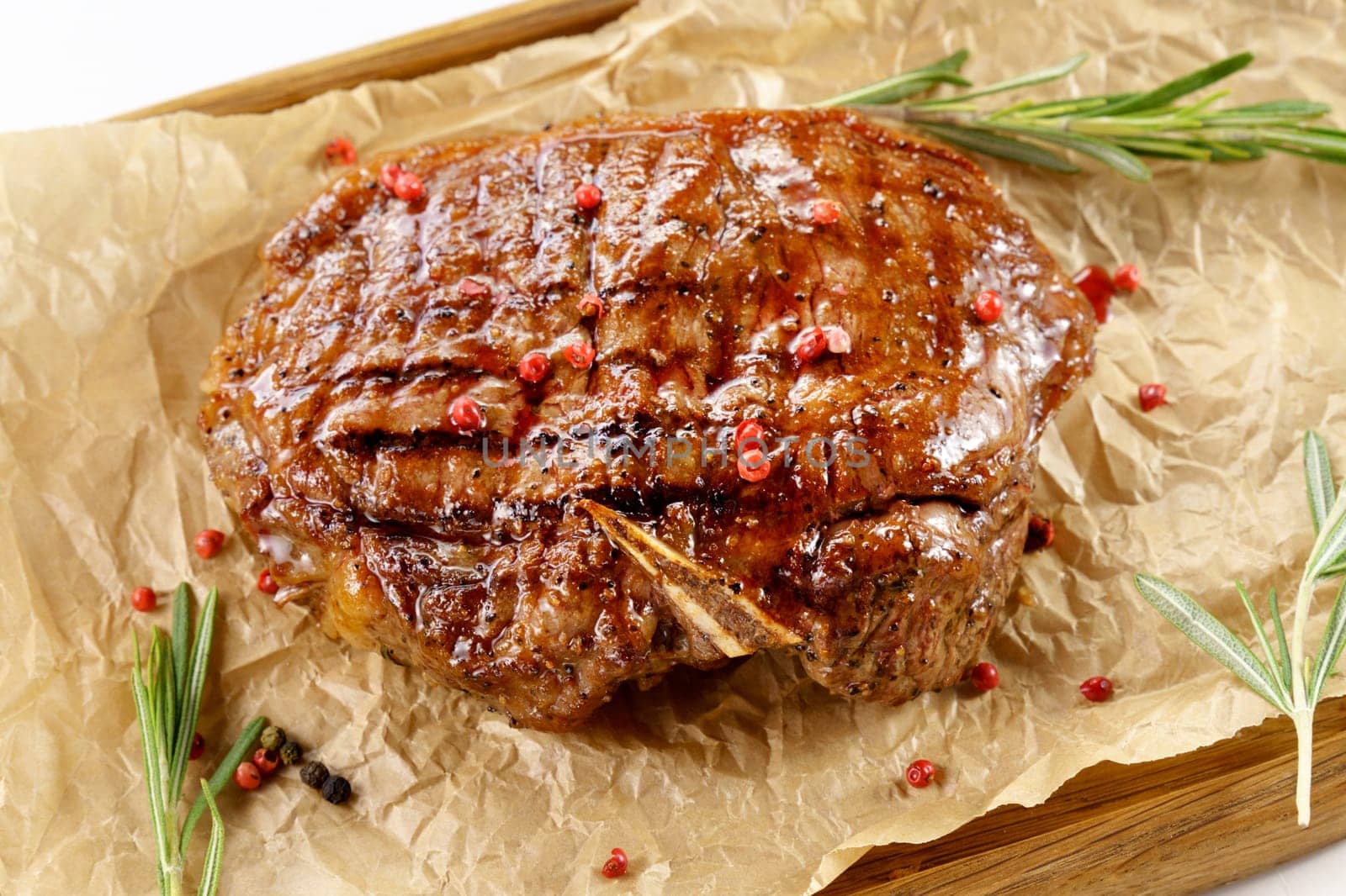Aged barbecue beef steak close up on wooden background. banner, menu.
